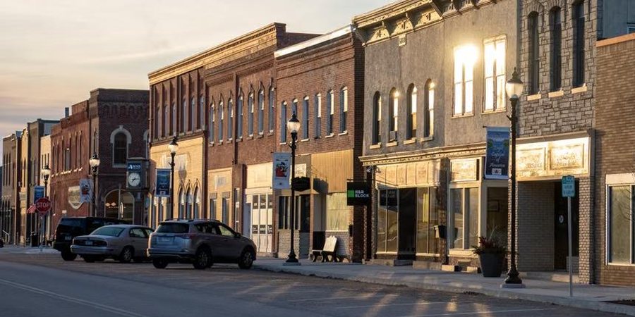 Historic brick main street storefronts in warm evening light